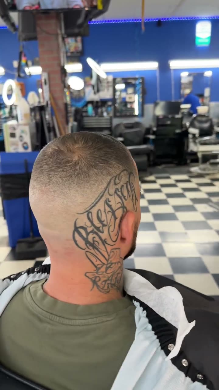 Skin fade with a neck tattoo, seen from behind
